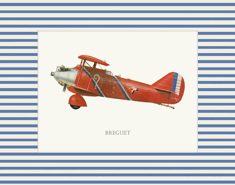 May include: A framed print of a vintage red biplane with blue and white accents. The biplane has a silver propeller and the word "BREGUET" is printed below the plane. The frame has a blue and white striped pattern.
