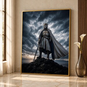 May include: A framed wall art print depicting a knight in silver armour and a crown, wearing a white tunic with a cross emblem and a long cape. The figure stands on a dark rocky peak against a dramatic, cloudy sky holding a long sword.