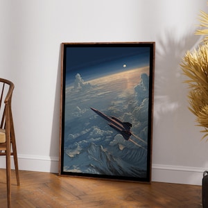 May include: A framed rectangular wall art print featuring a dark, sleek jet aircraft flying high above a dense layer of white clouds and rugged mountain peaks. The scene is set against a deep blue sky with a small, bright sun visible in the distance.