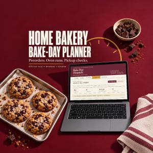 May include: A laptop displaying the Bake Day Dispatch software, a metal baking sheet with four chocolate chip cookies, a small bowl of chocolate chunks, and a striped cloth on a dark red surface. Text reads: HOME BAKERY BAKE-DAY PLANNER.
