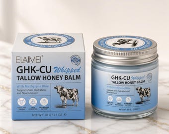 May include: A square cardboard box and a round glass jar of Elaimei GHK-CU Whipped Tallow Honey Balm. Both containers are light blue with white text, featuring a cow illustration and the label Net Wt: 60 g / 2.1 oz. The balm is for face and body.