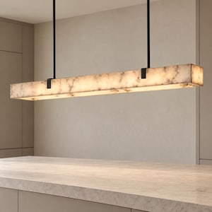 May include: A linear pendant light fixture featuring a long, rectangular shade made of white and gray marbled stone. The shade is suspended by two thin black metal rods attached to black brackets at each end of the light structure.