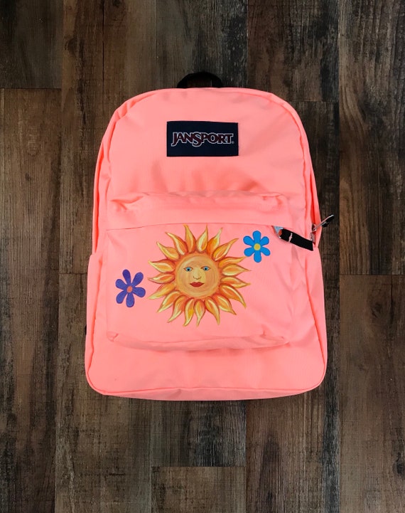 peach colored jansport backpack