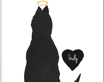 May include: A framed print featuring a black silhouette of a cat sitting with its back to the viewer. Above the cat is a yellow halo, and to the right is a black heart shape with the name Indy written in white script lettering.
