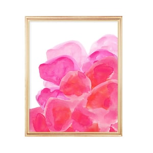 May include: Abstract watercolor painting with pink and red hues, resembling flower petals. The painting is framed in a gold frame.