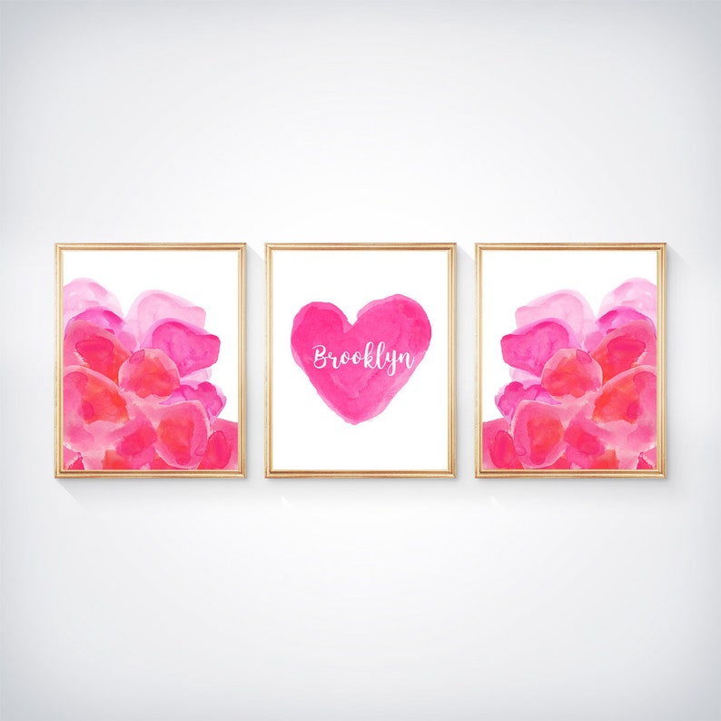 May include: Three framed watercolor prints with pink and red abstract shapes. The middle print features a pink heart with the name "Brooklyn" written in white.