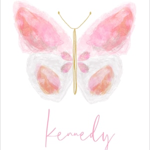 May include: A watercolor butterfly with pink and white wings and a gold outline. The name "Kennedy" is written in pink script below the butterfly.