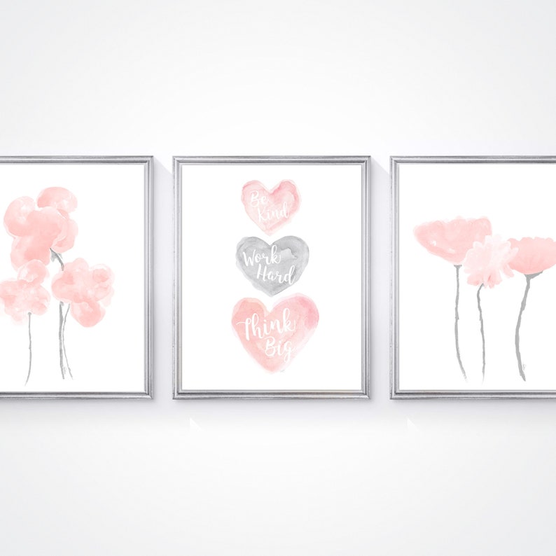 May include: Three framed prints with watercolor illustrations. The left print features pink flowers. The center print features three hearts with the text "Be Kind", "Work Hard", and "Think Big". The right print features pink flowers.