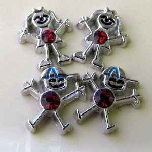 May include: Four silver charm pendants with red rhinestone accents. Two charms feature a girl with a crown and two charms feature a boy wearing a blue hat.