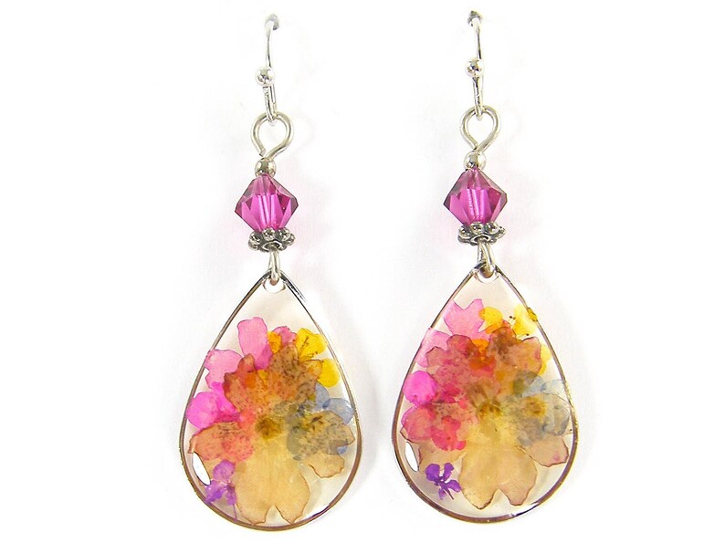 Colorful flower earrings feature real pressed, dried flowers in a clear resin teardrop. These pink and yellow multi-color earrings have a magenta Swarovski crystal bead accent. Lovely as spring or summer dangle earrings or any time of the year.