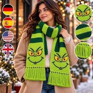 May include: A lime green and dark green striped crochet scarf featuring a stitched character face with yellow eyes and a black grin on both ends. The scarf is finished with long lime green fringe tassels at the bottom edges of the fabric.