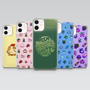 May include: Five clear smartphone cases featuring pixel art designs. One is yellow with a chicken, one pink with small icons, one green with the Stardew Valley logo, one blue with aquatic icons, and one purple with various food and plant items.