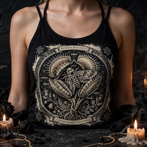 May include: A black vest top featuring a detailed beige graphic print of a Venus flytrap capturing a moth. The design includes the text DIONAEA MUSCIPULA and CAPTURA MORTIS ANATOMICA, surrounded by geometric patterns, ferns, and botanical elements.