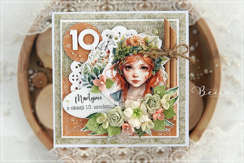 May include: A handmade card with a floral design featuring a girl with red hair wearing a flower crown. The card has a white background with a brown border and the text "Martynce z okazji 10. urodzin" in black.