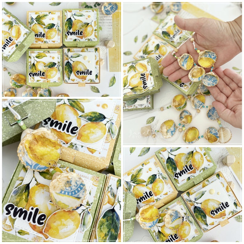 May include: A set of small, square boxes with a lemon and leaf design. Each box has the word "smile" printed on it. The boxes are arranged in a stack, and there are several other boxes in the background. The boxes are decorated with seashells and beads.