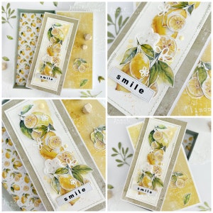 May include: A card with a watercolor illustration of lemons and leaves. The card has a white lace trim and the word "smile" written on it. The card is on a yellow background with a wooden embellishment.