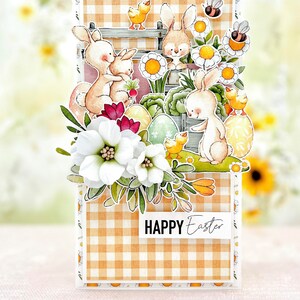 May include: A handmade Easter card with a gingham background and a pop-up design featuring bunnies, chicks, and flowers. The card says "HAPPY Easter" in black text.