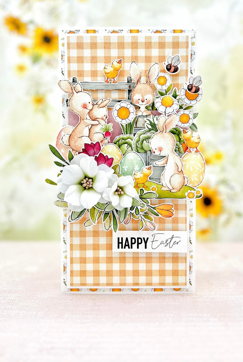 May include: A handmade Easter card with a gingham background and a pop-up design featuring bunnies, chicks, and flowers. The card says "HAPPY Easter" in black text.