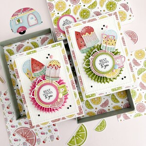 May include: Two white card blanks with a summer theme. The cards feature colorful illustrations of ice cream cones, popsicles, and fruit. The text on the cards reads "Best Wishes to you".