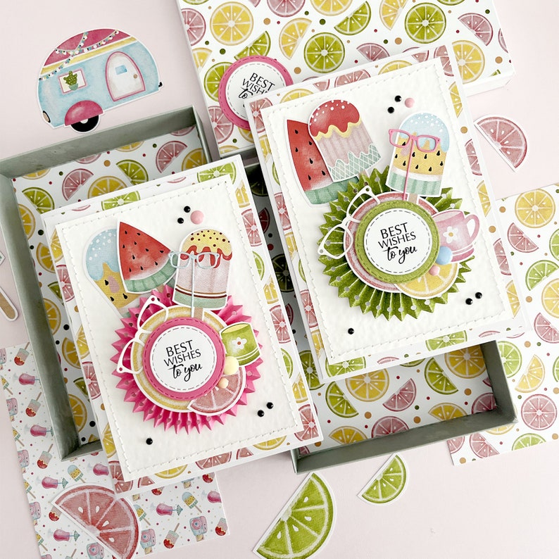 May include: Two white card blanks with a summer theme. The cards feature colorful illustrations of ice cream cones, popsicles, and fruit. The text on the cards reads "Best Wishes to you".