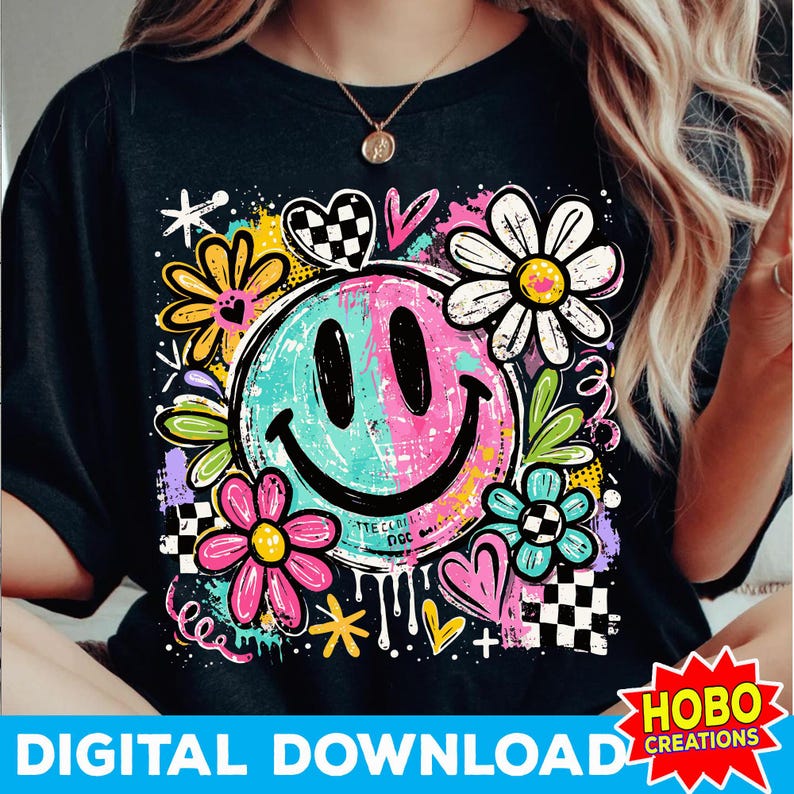 May include: Black t-shirt featuring a colorful smiley face design with flowers, hearts, and a checkered pattern. The smiley face is a mix of blue and pink. The words "DIGITAL DOWNLOAD" are at the bottom.