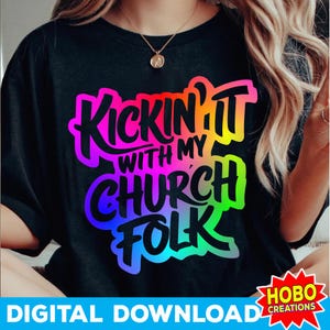 May include: Black t-shirt with the text "Kickin' It With My Church Folk" in a colorful, gradient design. The shirt also has the text "Digital Download" and a logo.