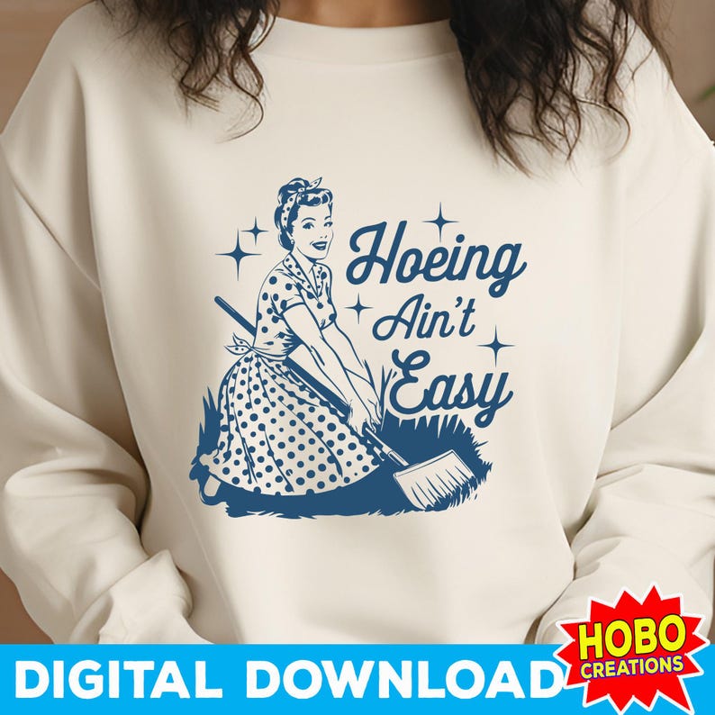 May include: A white sweatshirt with a blue graphic of a woman in a polka dot dress holding a rake. The text "Hoeing Ain't Easy" is written in blue above the woman.