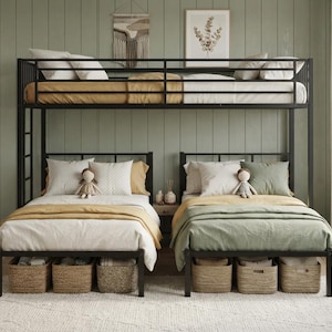 May include: A black metal bunk bed frame featuring a top twin bunk and two lower twin beds positioned side-by-side. The beds are dressed in white, mustard yellow, and sage green bedding with decorative pillows, small dolls, and woven storage baskets.