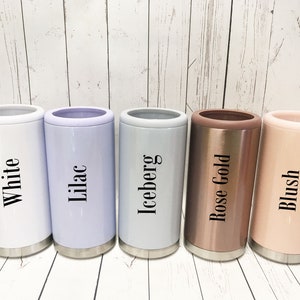 May include: Five insulated can coolers in different colors: white, lilac, light gray, rose gold, and blush. The coolers have the color names printed on them.