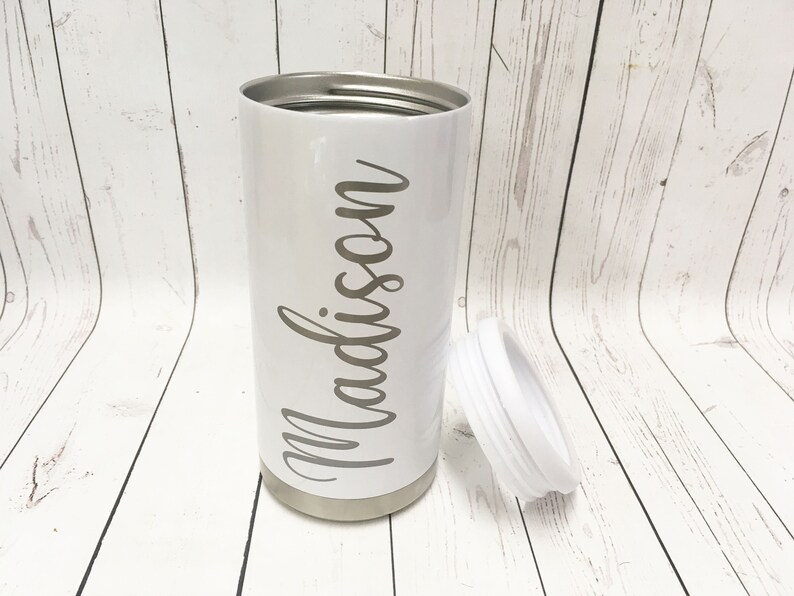 May include: White stainless steel tumbler with a white lid and the name "Madison" written in cursive on the side.