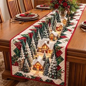 May include: A quilted table runner featuring a winter village scene with snow-covered houses, illuminated windows, and evergreen trees. The border displays a geometric pattern in red, green, and white, with a quilted texture throughout.