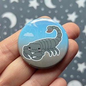 May include: A gray and blue button with a cartoon scorpion on a blue background with clouds. The scorpion has a cute, smiling face.