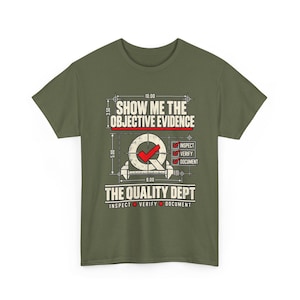 May include: An olive green t-shirt featuring a graphic with the text SHOW ME THE OBJECTIVE EVIDENCE and THE QUALITY DEPT. The design includes a caliper, a checkmark, and checkboxes labelled INSPECT, VERIFY, and DOCUMENT with numerical values.
