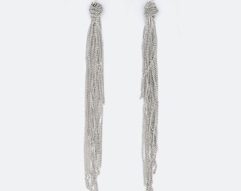 May include: A pair of long silver-toned drop earrings featuring a hook-style fastening. Each earring consists of a small knotted metal top section that transitions into a cascade of multiple thin, delicate silver chains hanging vertically.