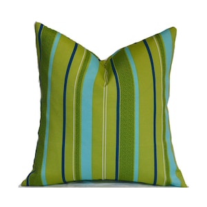 May include: Green, blue, and white striped throw pillow. The pillow is made of a soft, durable fabric and is perfect for adding a touch of color and style to any room.