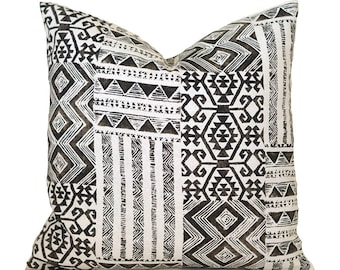 May include: Black and white geometric patterned throw pillow with a modern design.