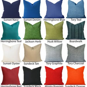 May include: A collection of sixteen square throw pillows in various colors and textures, labeled with names including Sunset Navy, Sunset Denim, Herringbone Blue, Tory Teal, Herringbone Teal, Jackson Herb, Husk Willow, Boardwalk, Sunset Oyster, Sundeck Tan, Tory Graphite, Tory Charcoal, Herringbone Red, Sundeck Black, Monty Pompeii, and Sundeck Orange.