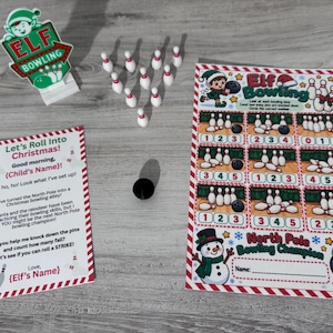 May include: An Elf Bowling game set featuring a sign, ten miniature white bowling pins, a black bowling ball, a printed instruction card titled Let's Roll Into Christmas, and a North Pole Bowling Champion activity sheet with counting tasks.