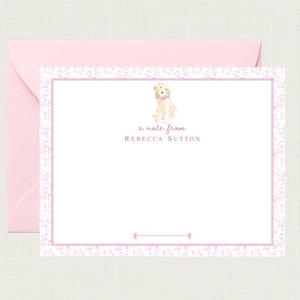 May include: A white card with a pink floral border. A watercolor illustration of a golden retriever wearing a pink flower collar is in the top center of the card. The text "a note from Rebecca Sutton" is below the illustration.