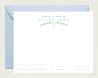 May include: A light blue stationery card with a green leafy garland and a blue ribbon. The text "from the nursery of BENJAMIN JAMES" is printed at the top. The date "SEPTEMBER 4 2020", the measurement "21 INCHES", and the weight "7 LBS 3 OZ" are printed at the bottom.