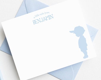 May include: A white card with a blue silhouette of a boy wearing a baseball cap. The text "a little note from BENJAMIN" is printed in blue at the top of the card.