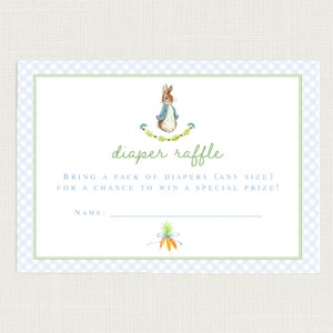 May include: A blue and white checkered card with a green border. The card features an illustration of Peter Rabbit, a green wreath, and the text "diaper raffle". The text below the illustration reads "Bring a pack of diapers (any size) for a chance to win a special prize!" and "Name:" with a blank line for the name.