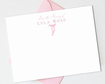 May include: A white card with pink text that reads "From the Nursery of LYLA ROSE" with a pink bow illustration.