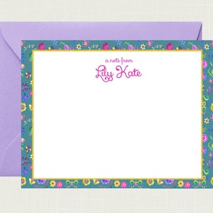 May include: A blue and white stationery card with a floral border. The card has a gold border and the text "a note from Lily Kate" in pink.