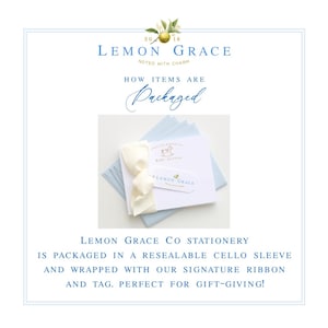 May include: Stationery set from Lemon Grace, packaged with a cream ribbon and tag. The set includes a white card with a baby-themed illustration and light blue envelopes. The packaging is in a resealable cello sleeve.
