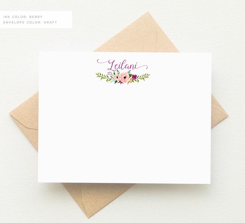 K&ouml;nnte beinhalten: Eine wei&szlig;e Briefpapierkarte mit einem Blumenkranz und dem Namen "Leilani" in violetter Tinte.