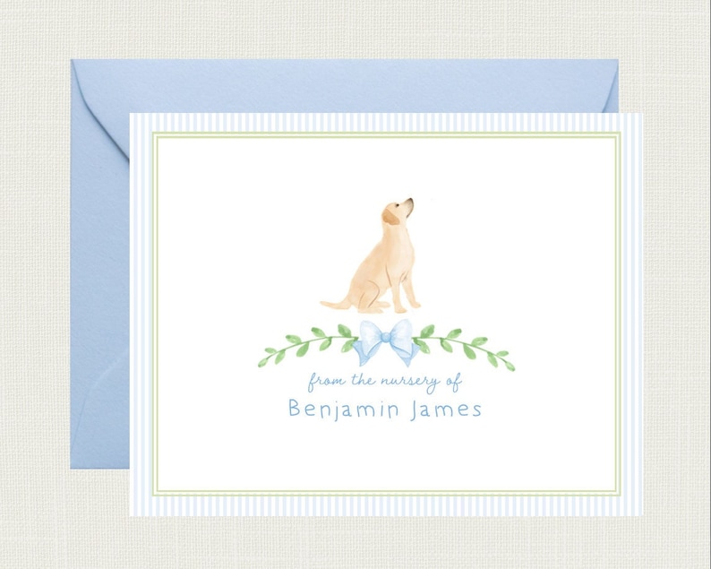 May include: A white card with blue and green stripes. A watercolor illustration of a yellow labrador retriever sitting with a blue bow. The text "from the nursery of Benjamin James" is printed on the card.