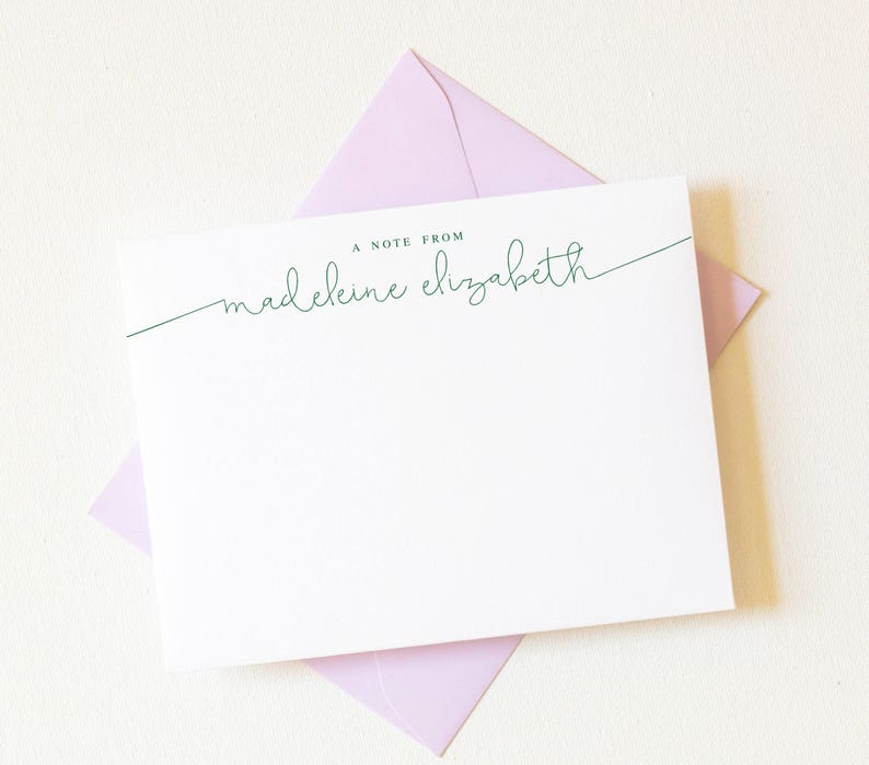 May include: A white notecard with a light pink envelope. The notecard has the text "A Note From madeleine elizabeth" in green cursive.
