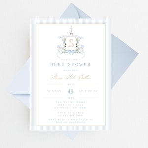 Pode incluir: Um convite para um ch&aacute; de beb&ecirc; em listras azuis e brancas com uma ilustra&ccedil;&atilde;o em aquarela de uma Torre Eiffel com tema parisiense com uma coroa de flores e a letra "S" no centro. O texto diz "Join us for a Bebe Shower honoring Anna Kale Dullan, Sunday, October 6th at 3:00 PM, The Sutton Home, 1204 Any Street, Anywhere, MO 12345, RSVP to Lauren at 123-456-7890, Anna Kate is registered at Babylist and Amazon."