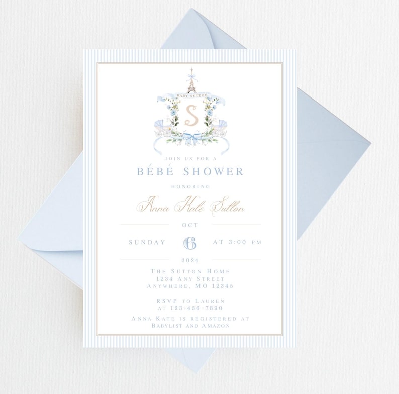 Pode incluir: Um convite para um ch&aacute; de beb&ecirc; em listras azuis e brancas com uma ilustra&ccedil;&atilde;o em aquarela de uma Torre Eiffel com tema parisiense com uma coroa de flores e a letra "S" no centro. O texto diz "Join us for a Bebe Shower honoring Anna Kale Dullan, Sunday, October 6th at 3:00 PM, The Sutton Home, 1204 Any Street, Anywhere, MO 12345, RSVP to Lauren at 123-456-7890, Anna Kate is registered at Babylist and Amazon."